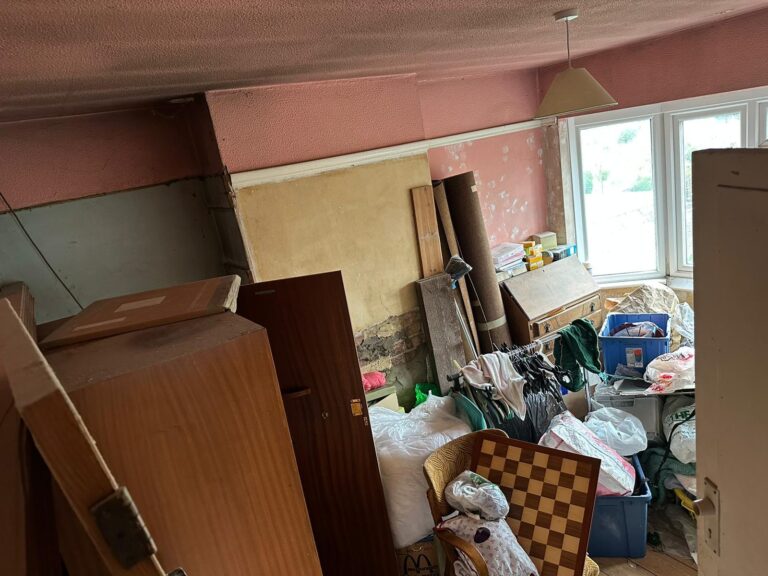 Room full of old furniture and household items before a clearance