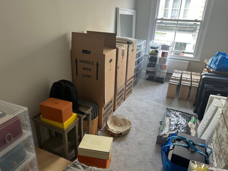 Boxes, bags and belongings packed and ready in a room before a move