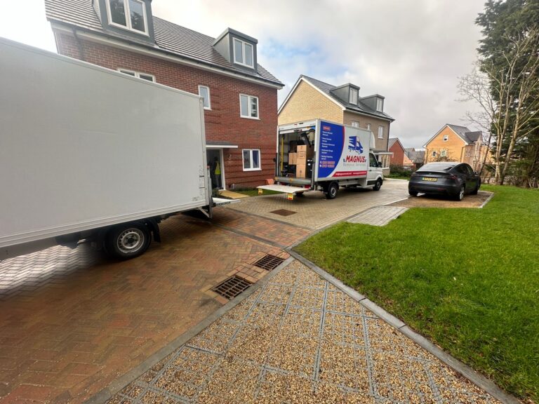 Magnus Removals vans parked on the driveway of a new-build house