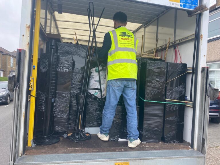 Magnus team member loading wrapped furniture into a removal van