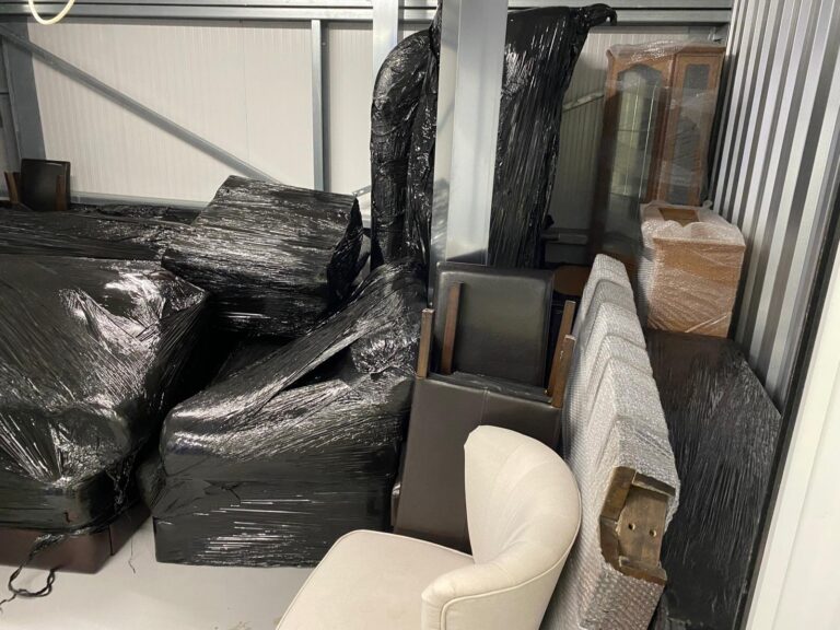 Furniture wrapped in protective film, loaded and stacked