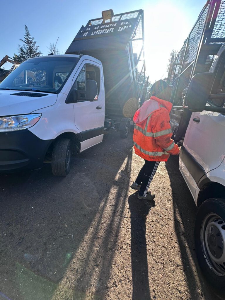 Magnus team member beside a loaded clearance vehicle