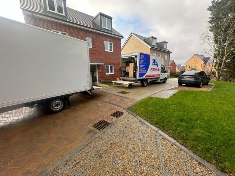 Magnus Removals vans loading at a new-build house