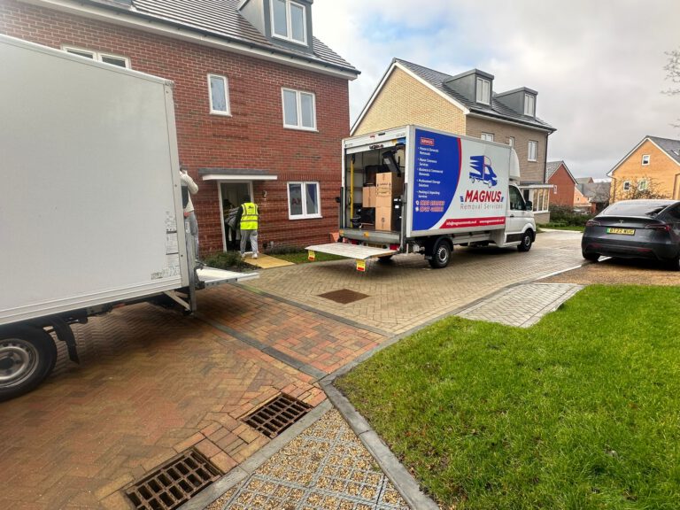 Magnus Removals vans parked on the driveway of a new-build house