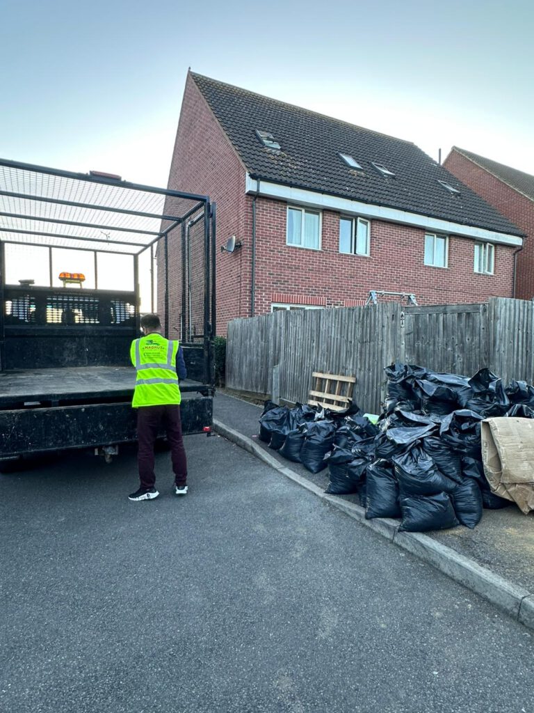 Magnus team member loading rubbish bags for removal