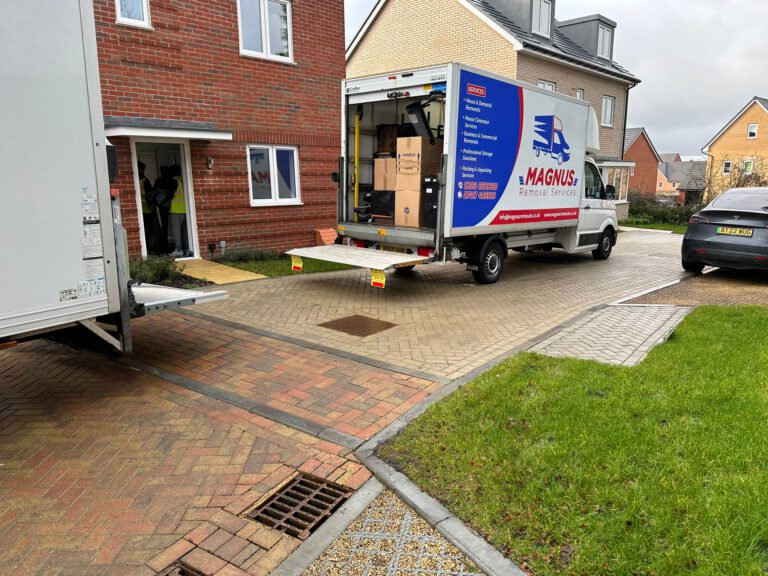 Magnus Removals van with tail lift lowered outside a house