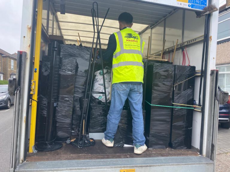 Magnus Removals team member loading wrapped furniture into a van