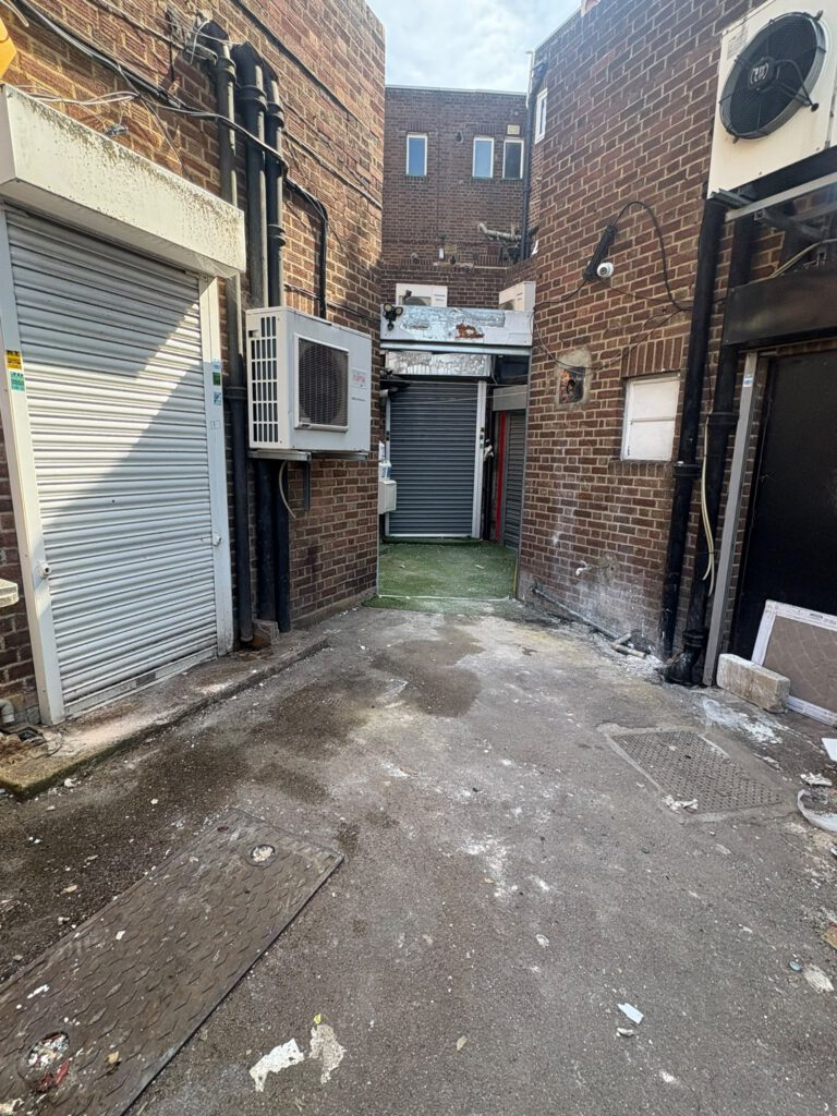Rear service alley after commercial waste clearance