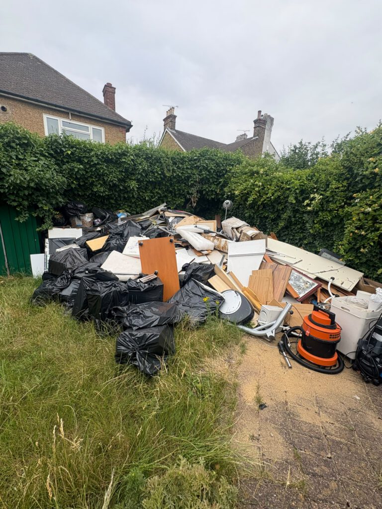 Garden full of rubbish before removal