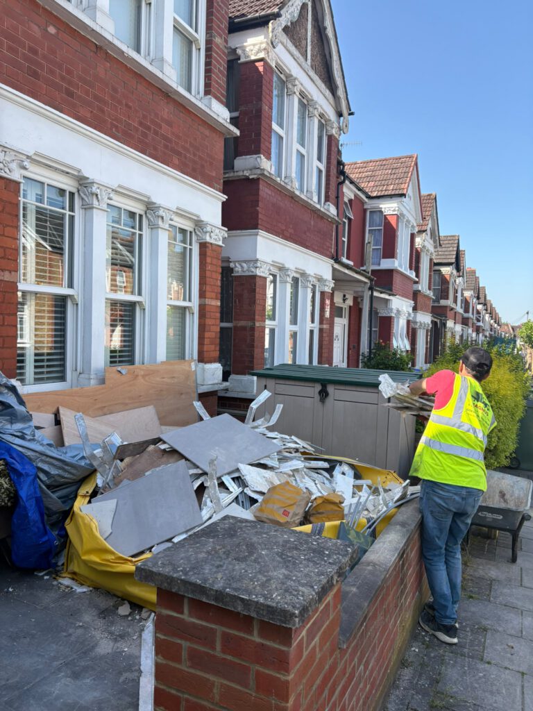 Magnus team member clearing waste from a front garden