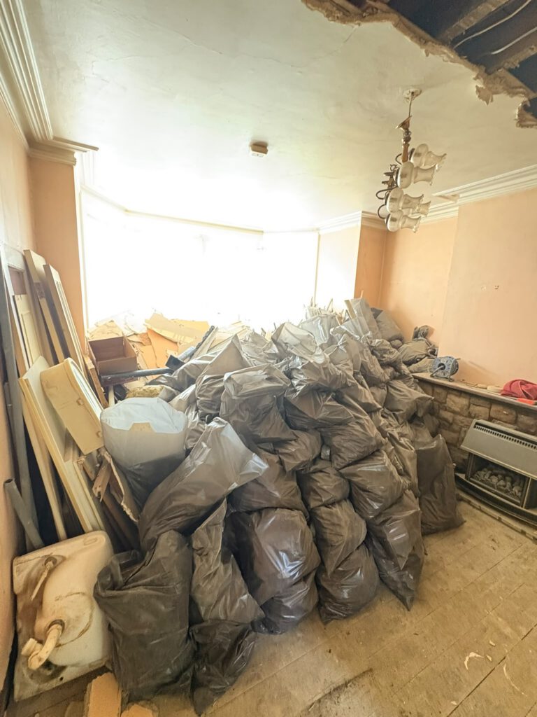 Room filled with rubble bags before a house clearance