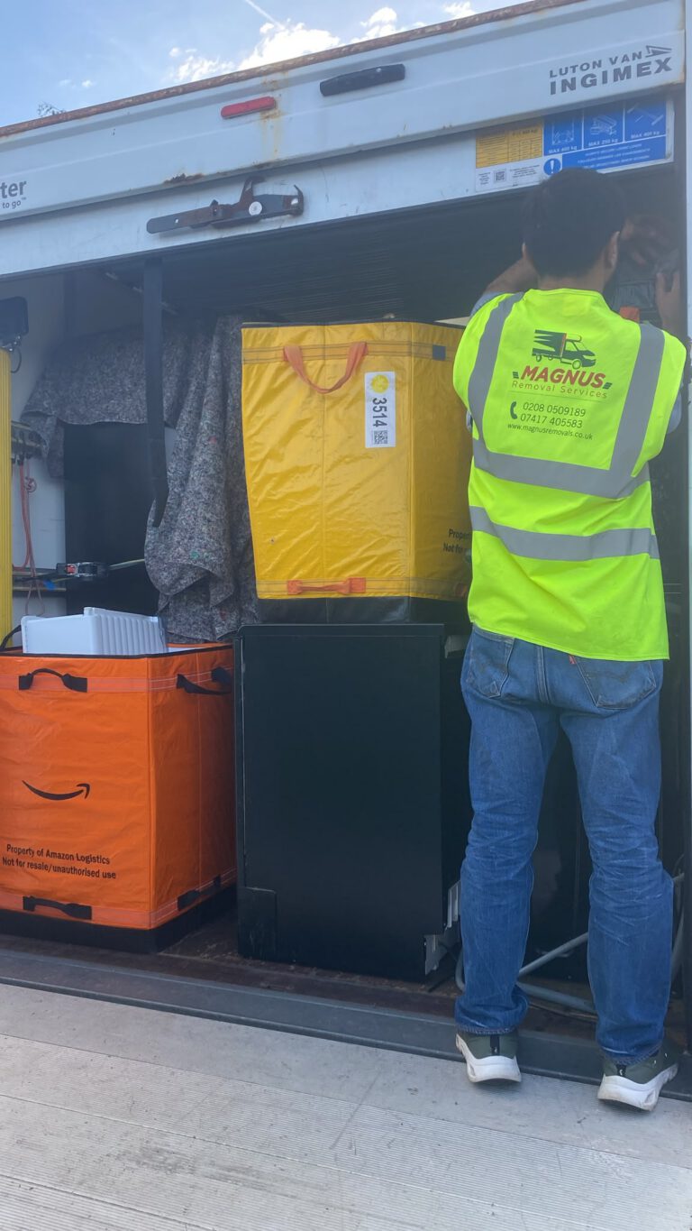 Magnus Removals team member loading crates into the van